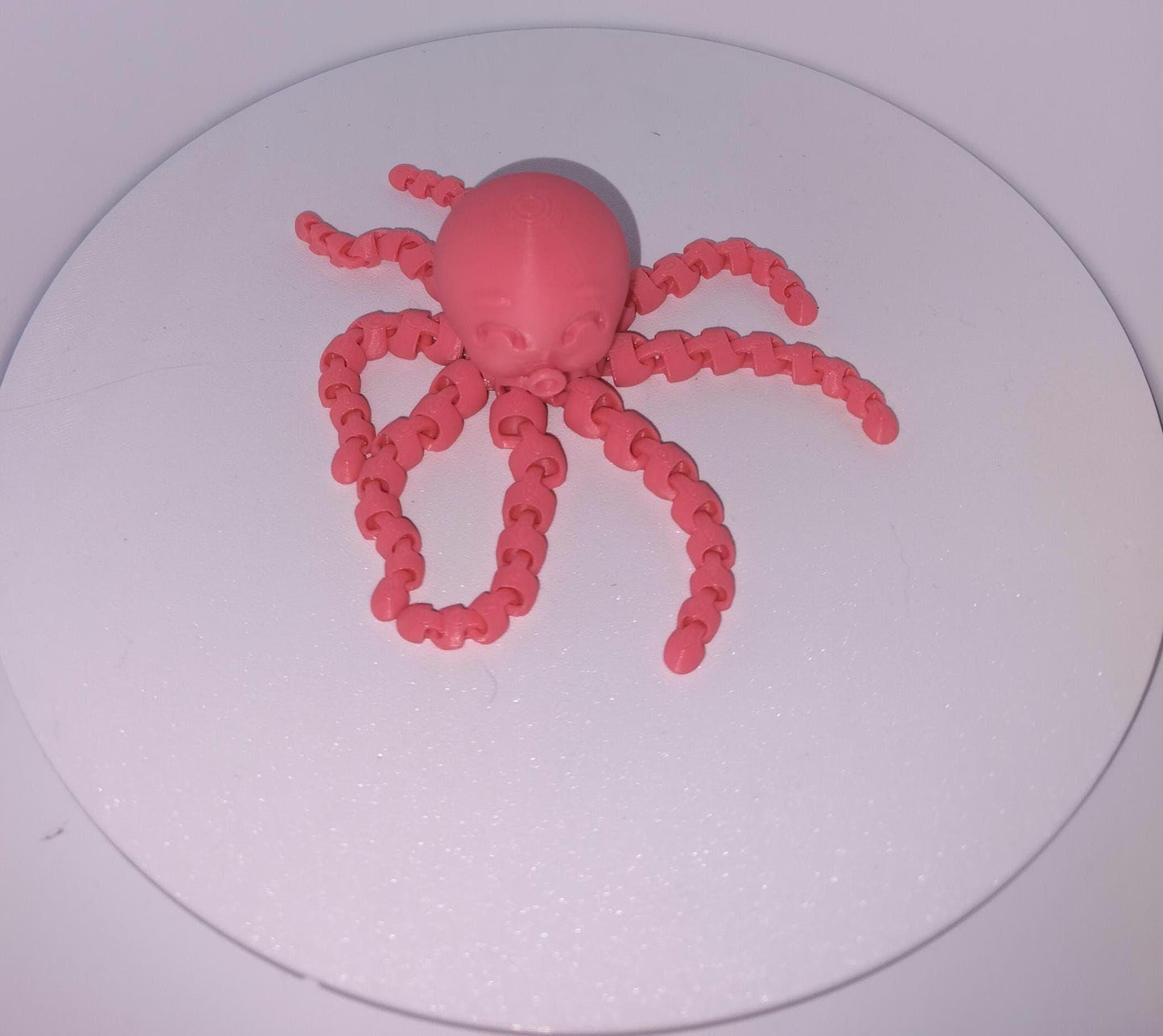 Featuring A Pink Articulated Octopus with 8 chained legs. Front profile