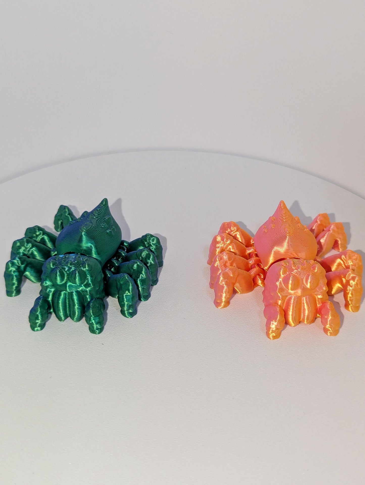 Front view of the green and orange spiders