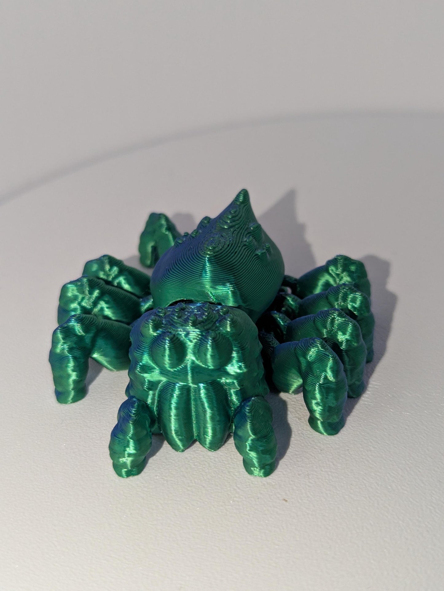 Up-close front view of the green spider