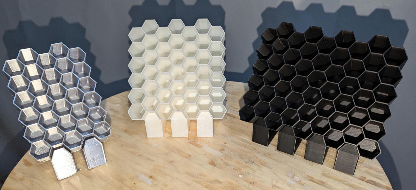 featuring one black ,one white , and one silver posca marker holder. Showing three different sizes. Front profile