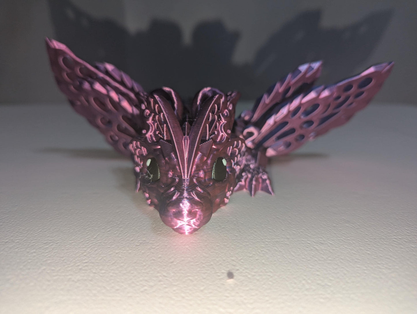 Face shot of the purple/blue baby winged articulated dragon.