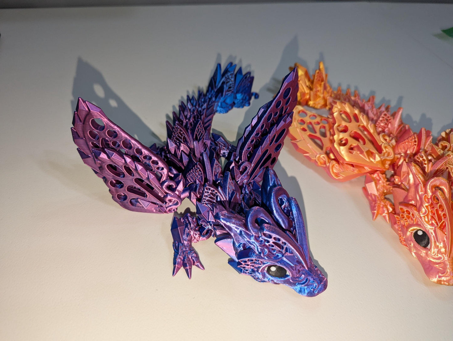 Side view of the purple/blue winged baby articulated dragon.