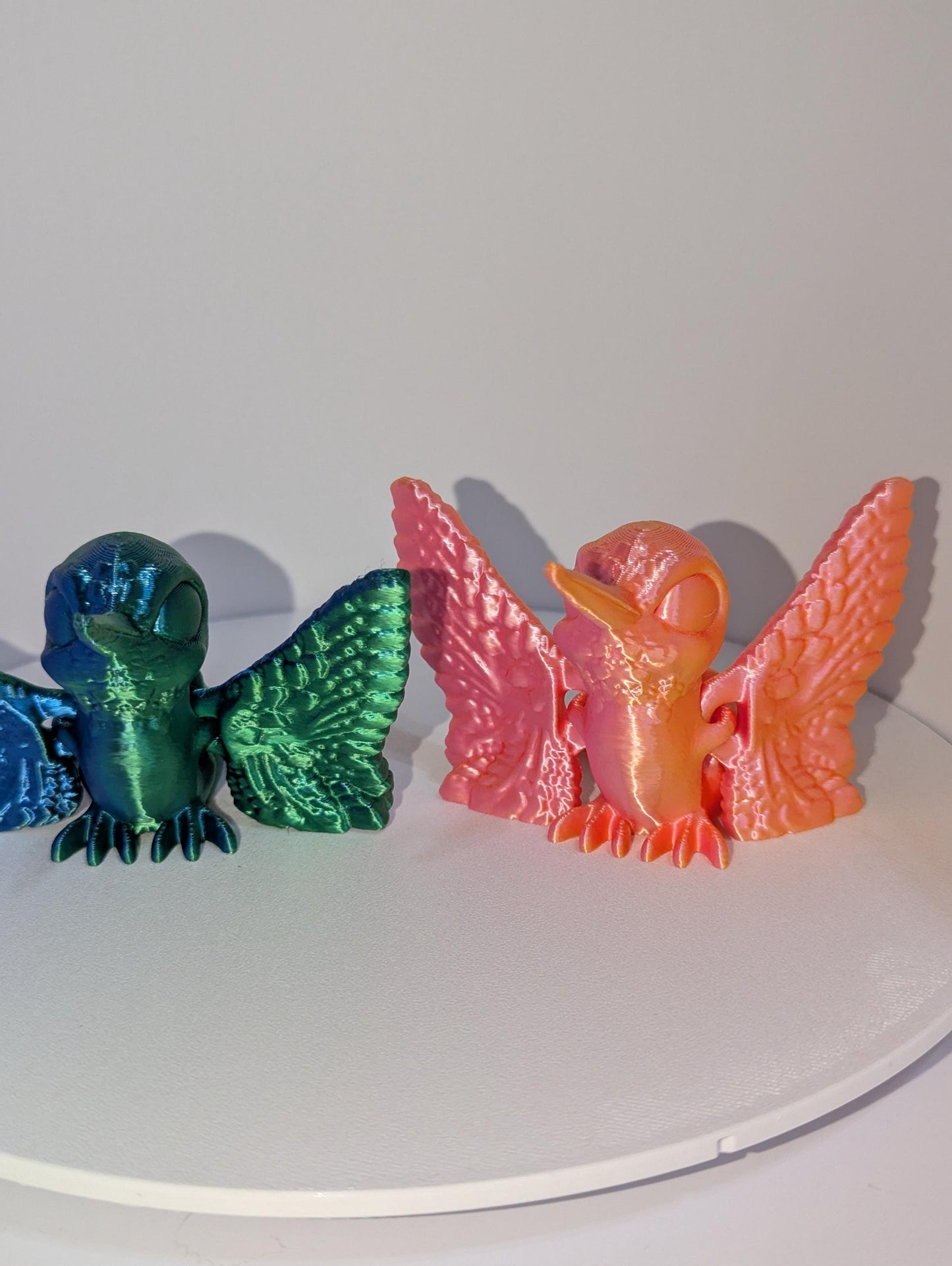 Featuring two humming birds one in green/blue and one in orange/pink