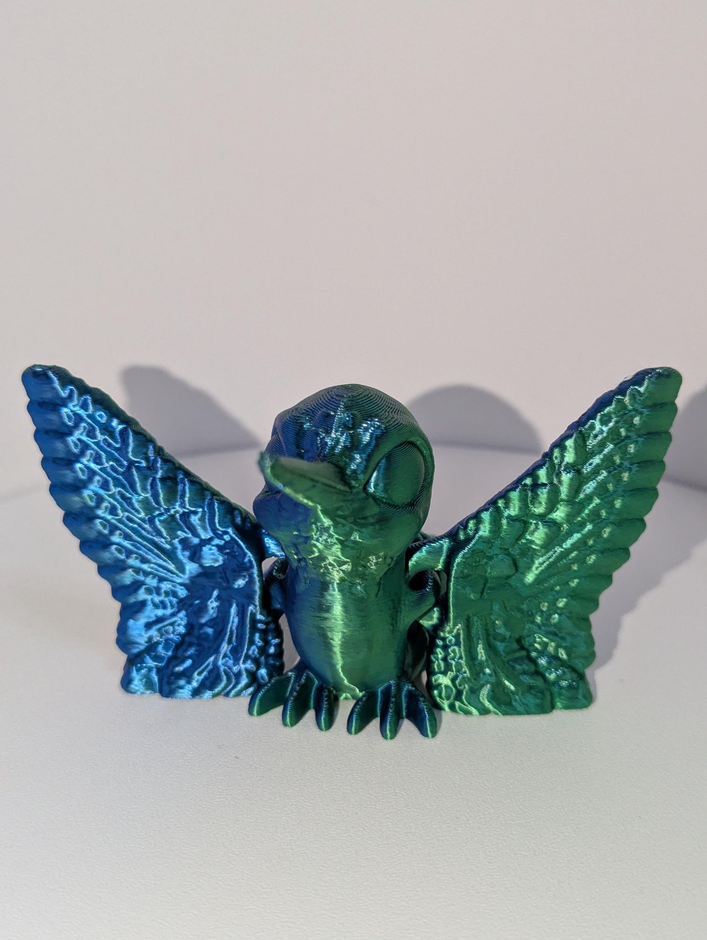 Green/blue humming bird front profile