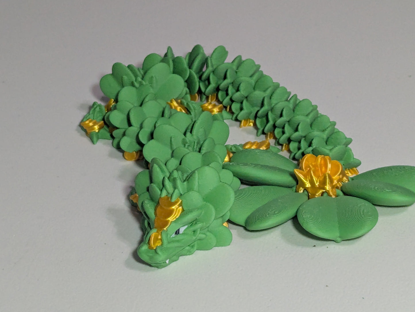 Lucky Clover Articulating Baby Dragon Initiative Design