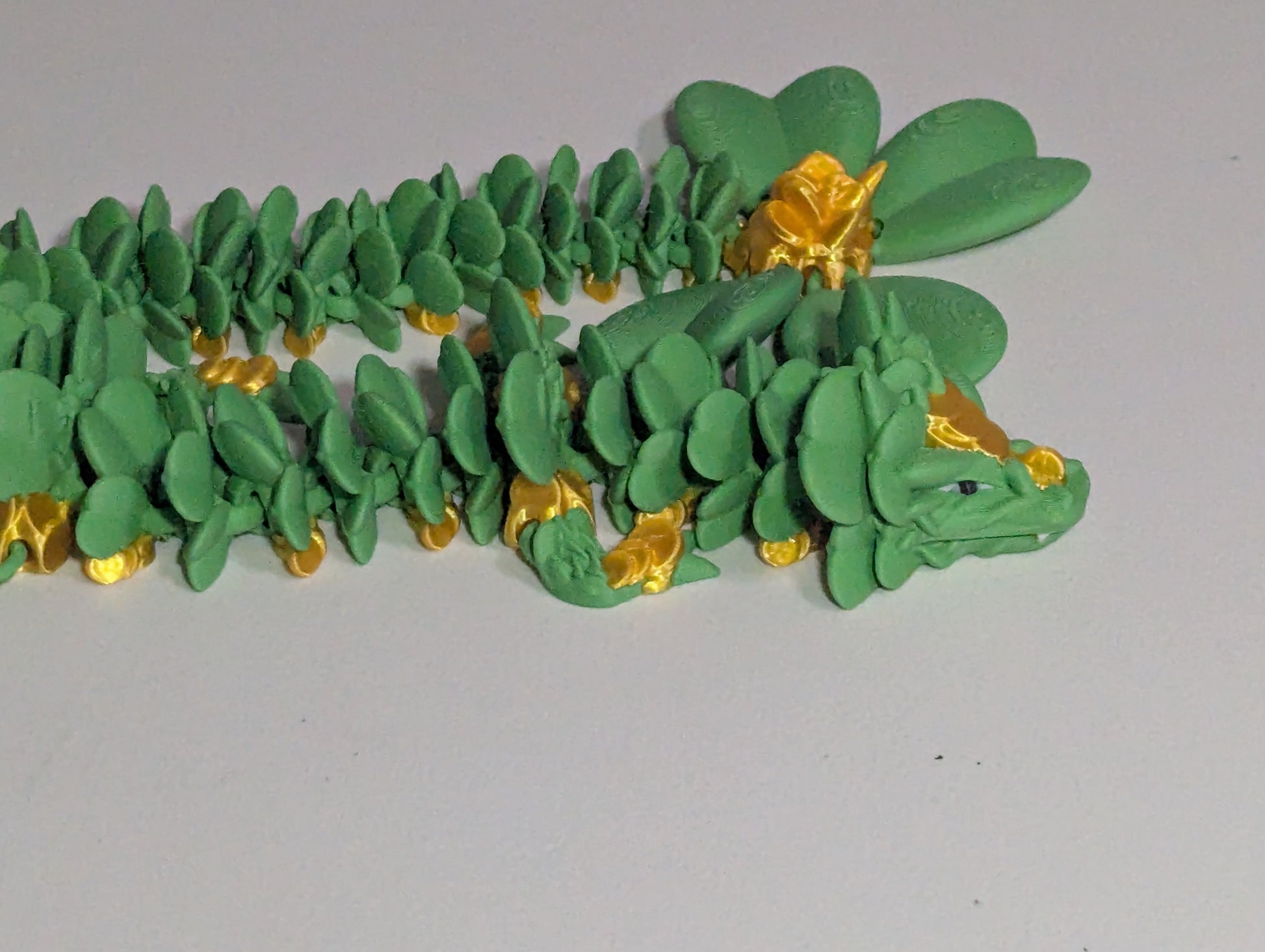 Lucky Clover Articulating Baby Dragon Initiative Design