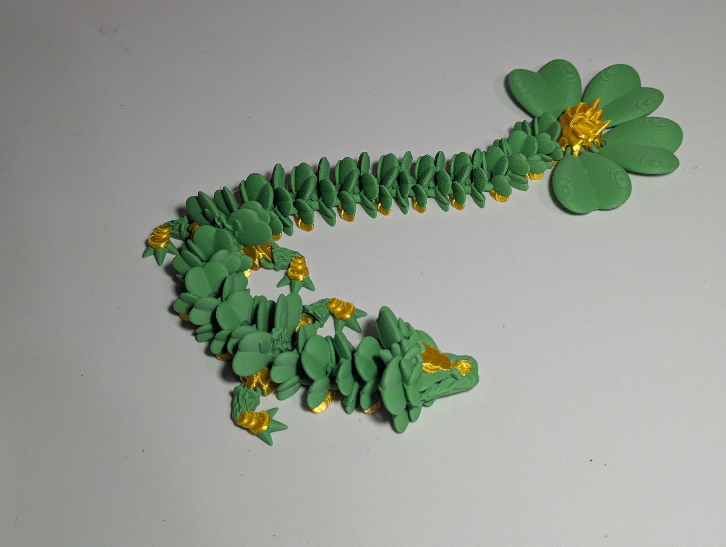 Lucky Clover Articulating Baby Dragon Initiative Design