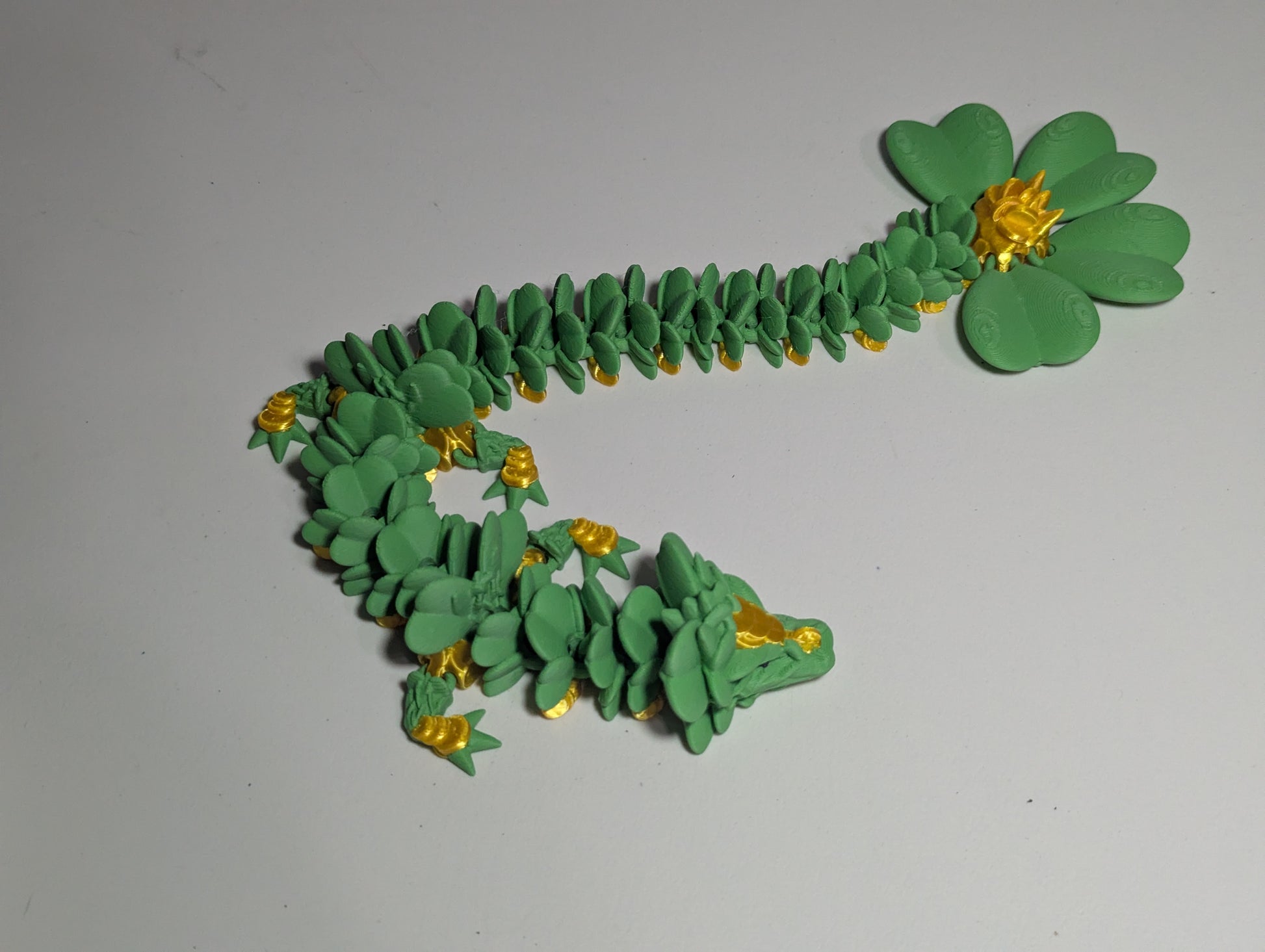 Lucky Clover Articulating Baby Dragon Initiative Design