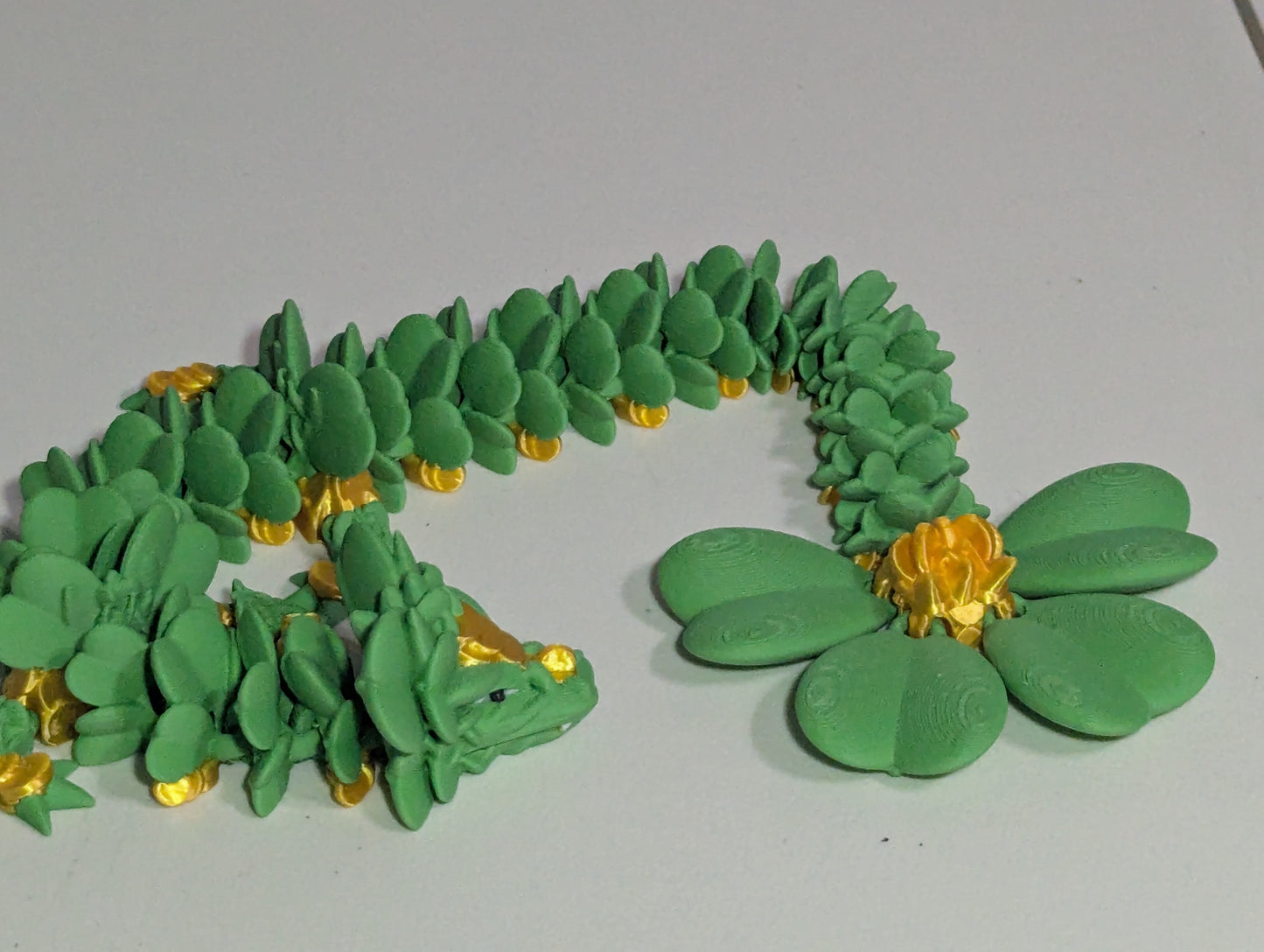 Lucky Clover Articulating Baby Dragon Initiative Design