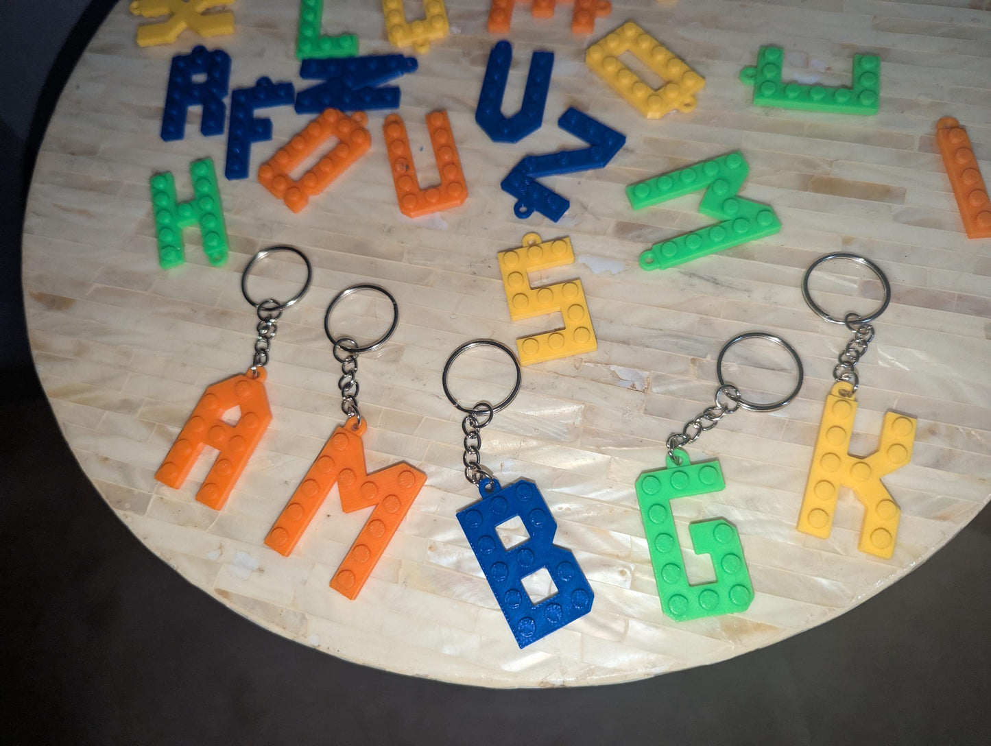 Letter Lego key chains in different colors. Zoomed in photo
