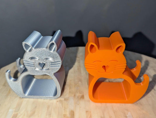 Featuring two adorable cat phone holders front profile one in silver one in orange