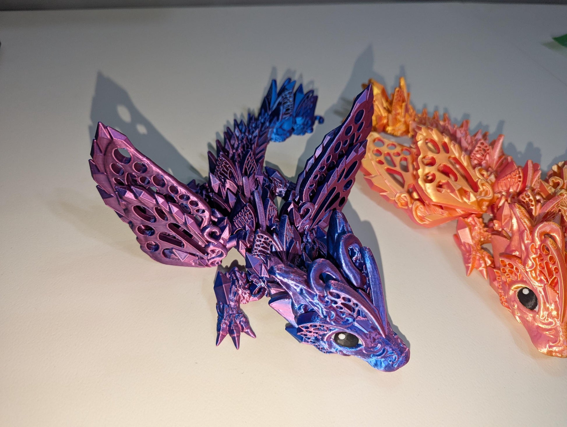 Side view of the purple/blue winged baby articulated dragon.