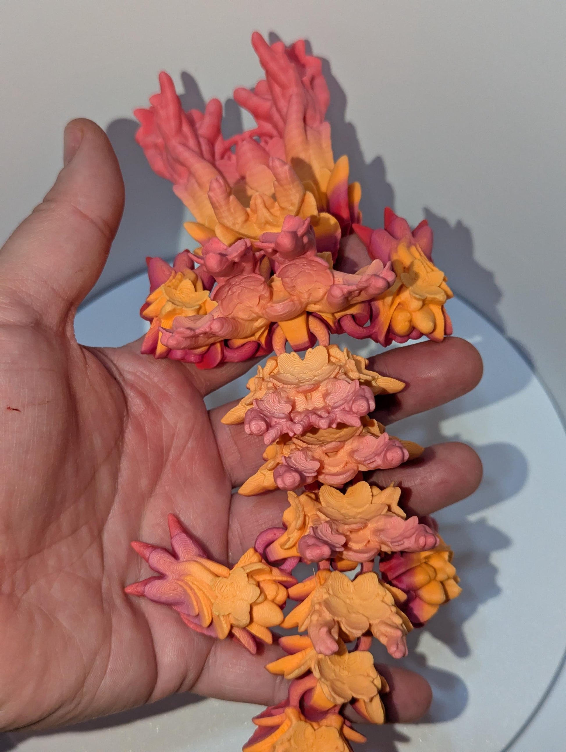 Flower details down the spine of this cherry blossom articulated dragon.