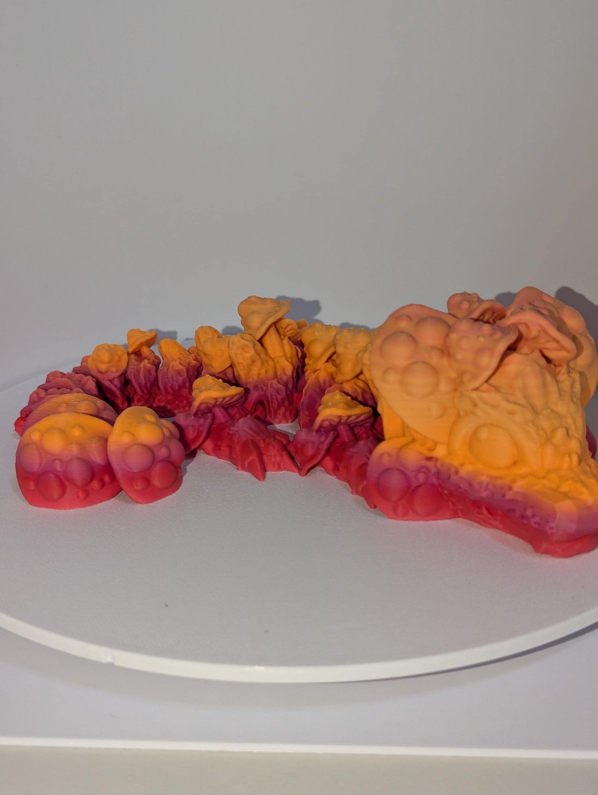 Side profile of this adorable mushroom dragon curled up.