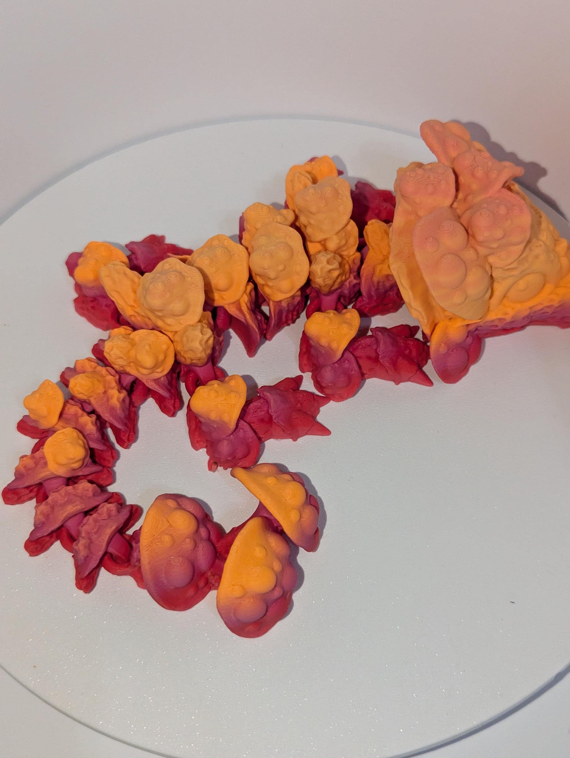 Shows the mushroom spine and tail up-close details on this mushroom dragon.